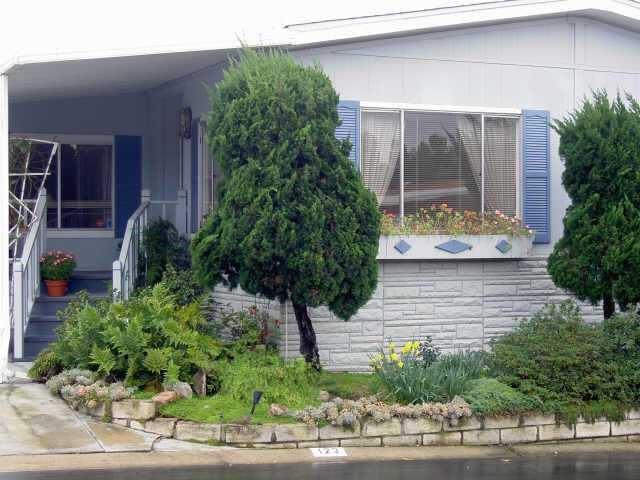 1195 La Moree Road, Unit 123 San Marcos, CA 92078 - Photo 1 of 1 Charming front entrance with plenty of flowers and mature shrubs.