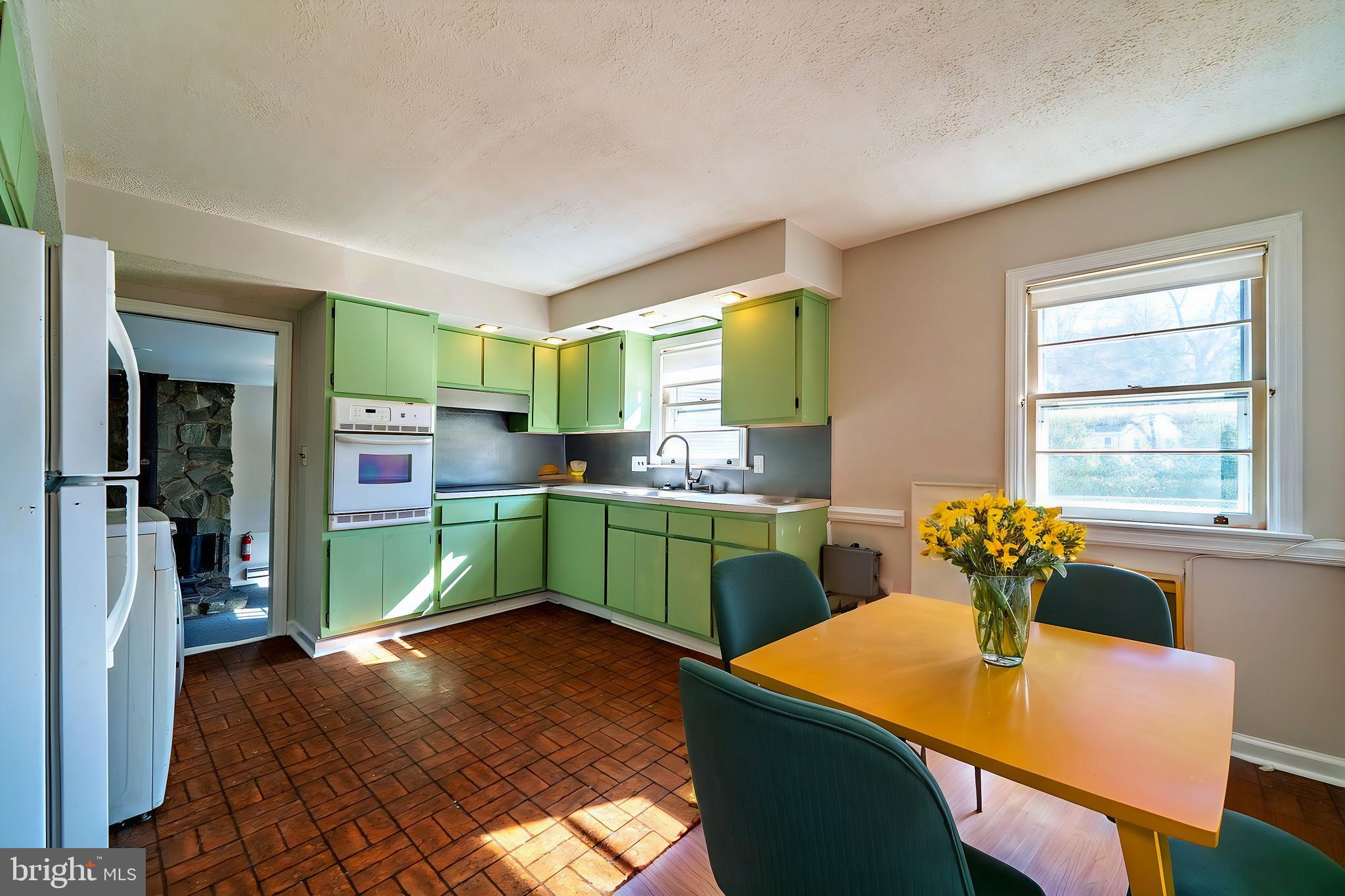 321 Wynnewood Road Ewing, NJ 08628 - Photo 11 of 31 a kitchen with cabinets a table and chairs in it