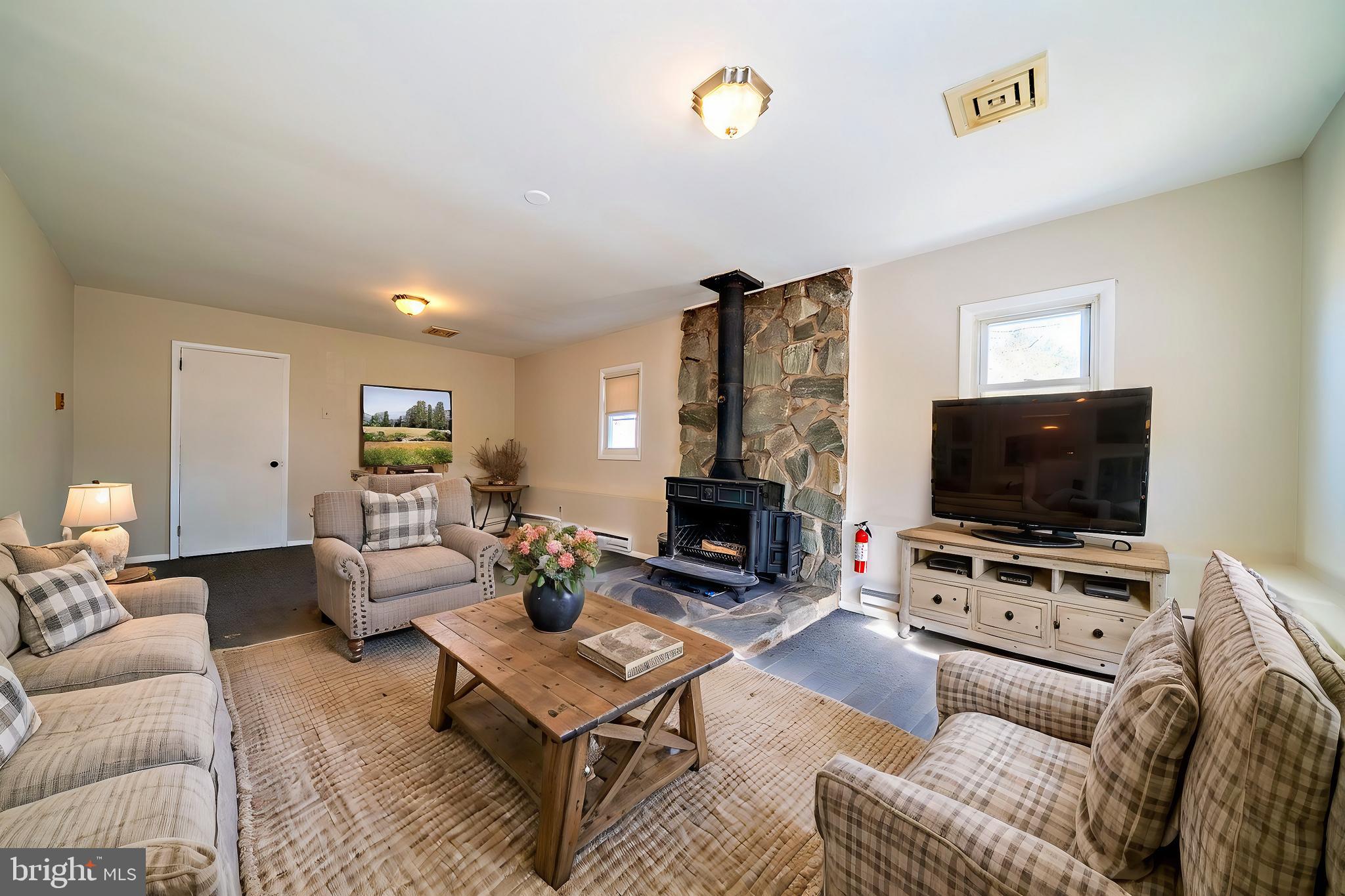 321 Wynnewood Road Ewing, NJ 08628 - Photo 14 of 31 a living room with furniture and a flat screen tv