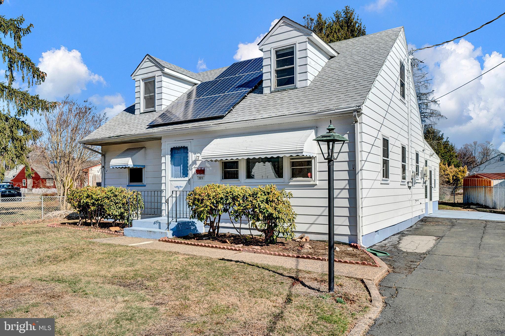 321 Wynnewood Road Ewing, NJ 08628 - Photo 2 of 31 a front view of a house with a yard and outdoor seating