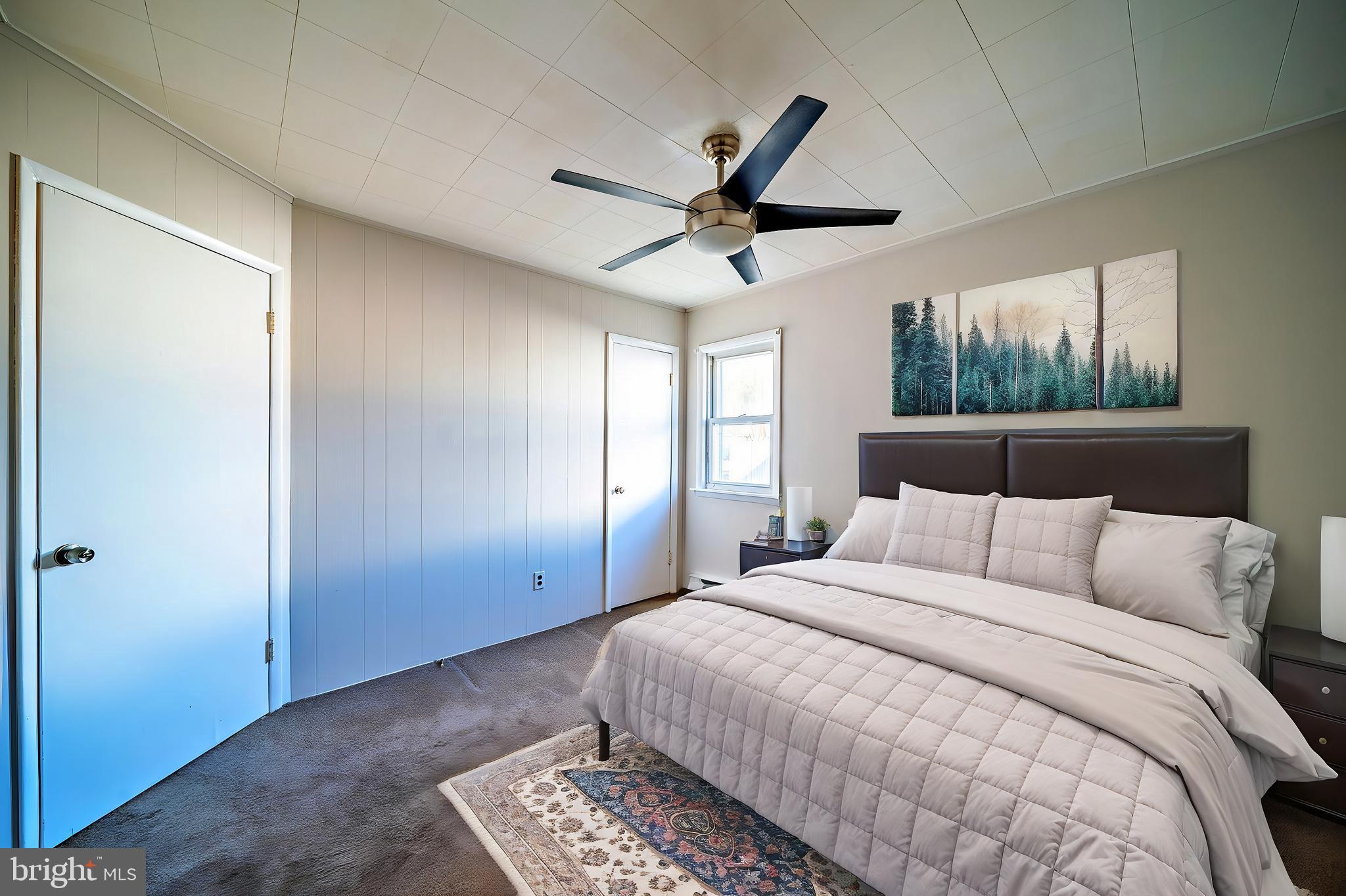 321 Wynnewood Road Ewing, NJ 08628 - Photo 23 of 31 a bedroom with a large bed and a ceiling fan