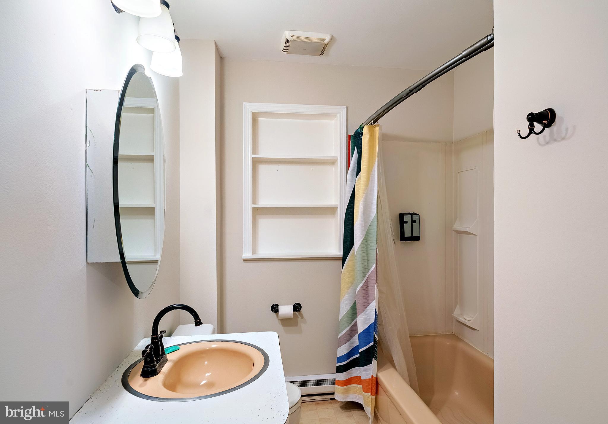321 Wynnewood Road Ewing, NJ 08628 - Photo 24 of 31 a bathroom with a sink a mirror a bathtub and shower