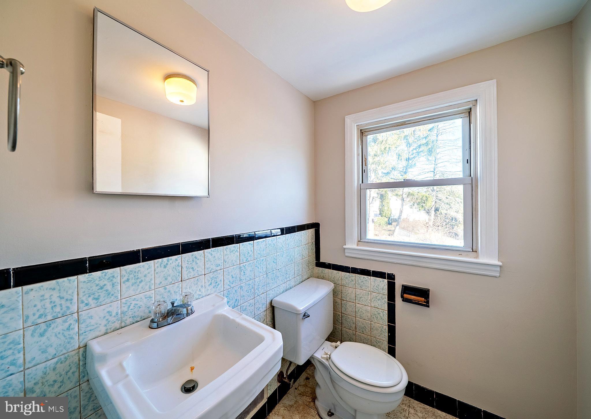 321 Wynnewood Road Ewing, NJ 08628 - Photo 29 of 31 a bathroom with a sink a toilet and a mirror