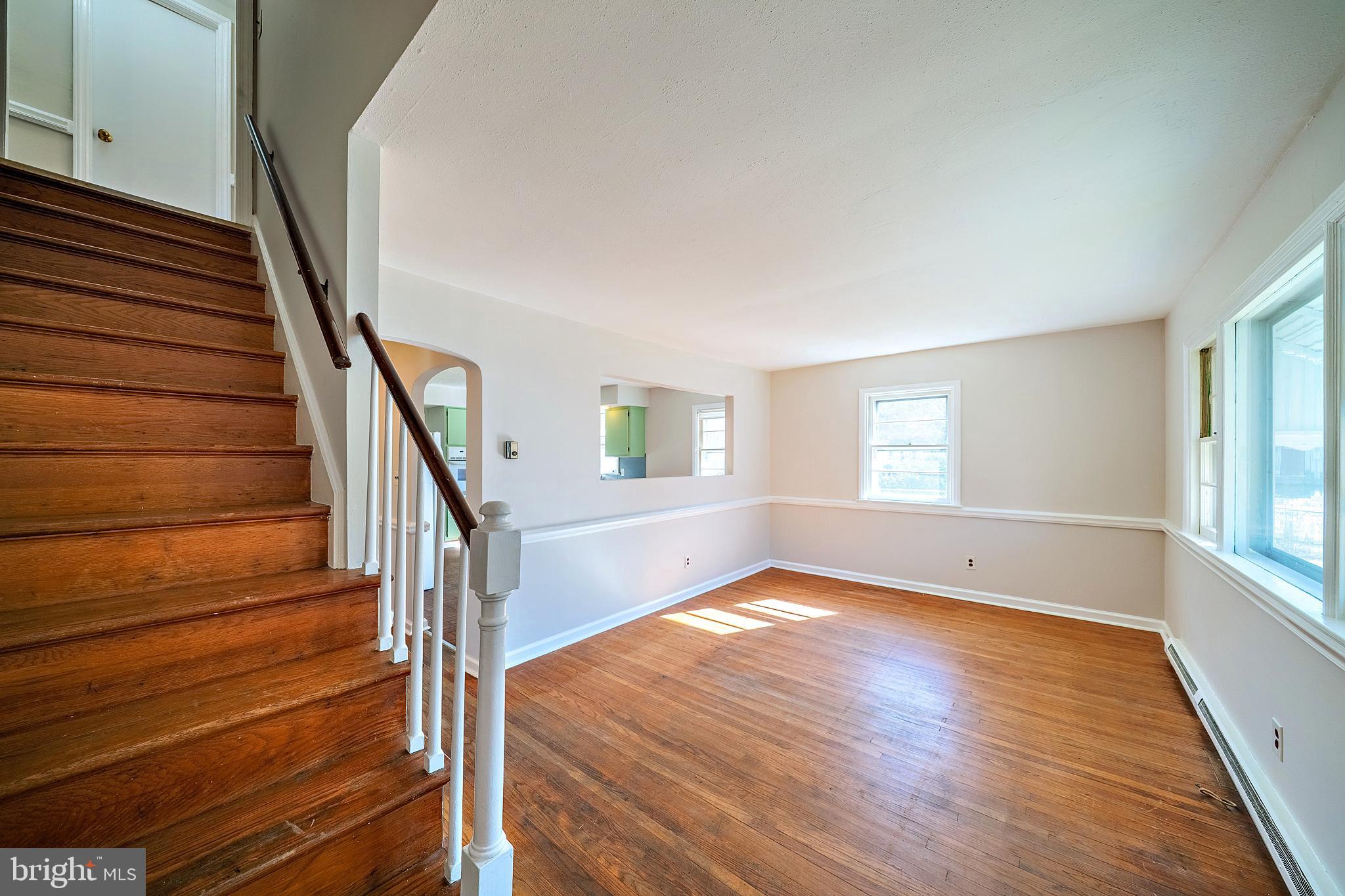 321 Wynnewood Road Ewing, NJ 08628 - Photo 4 of 31 a view of an empty room with wooden floor and fan