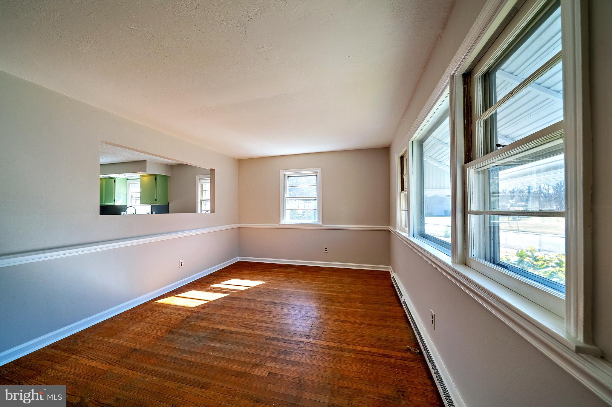 321 Wynnewood Road Ewing, NJ 08628 - Photo 5 of 31 a view of an empty room with wooden floor and a window