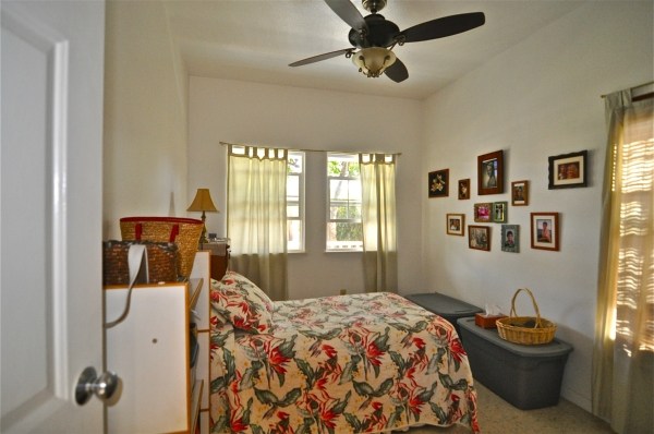 8630 Elepaio Road Kekaha, HI 96752 - Photo 12 of 20 a bedroom with a bed and wooden floor