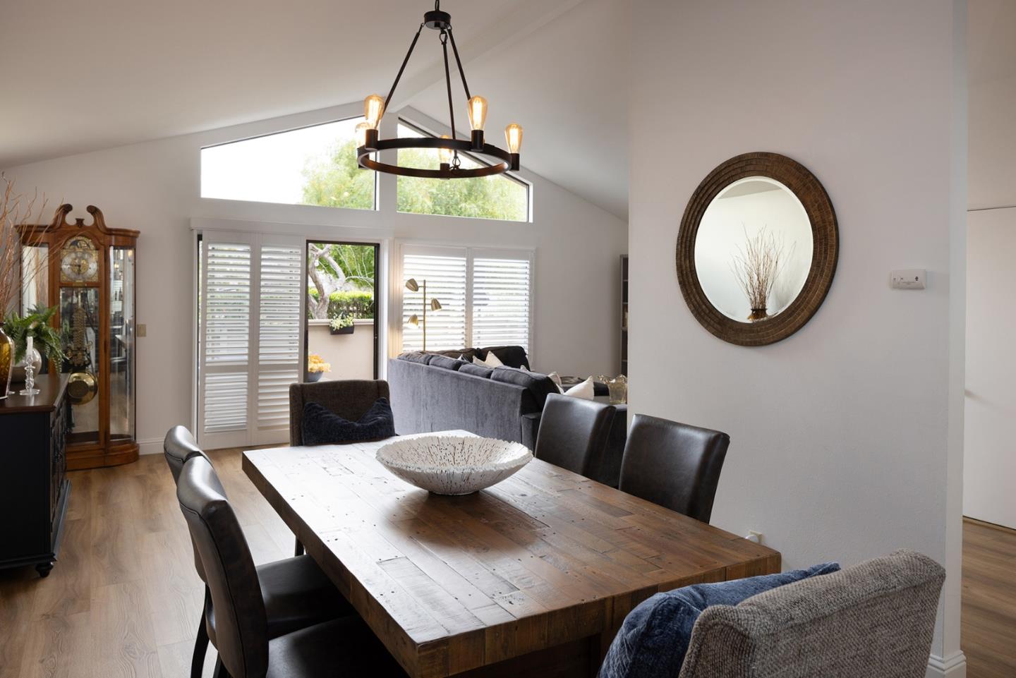a view of a dining room with furniture and chandelier