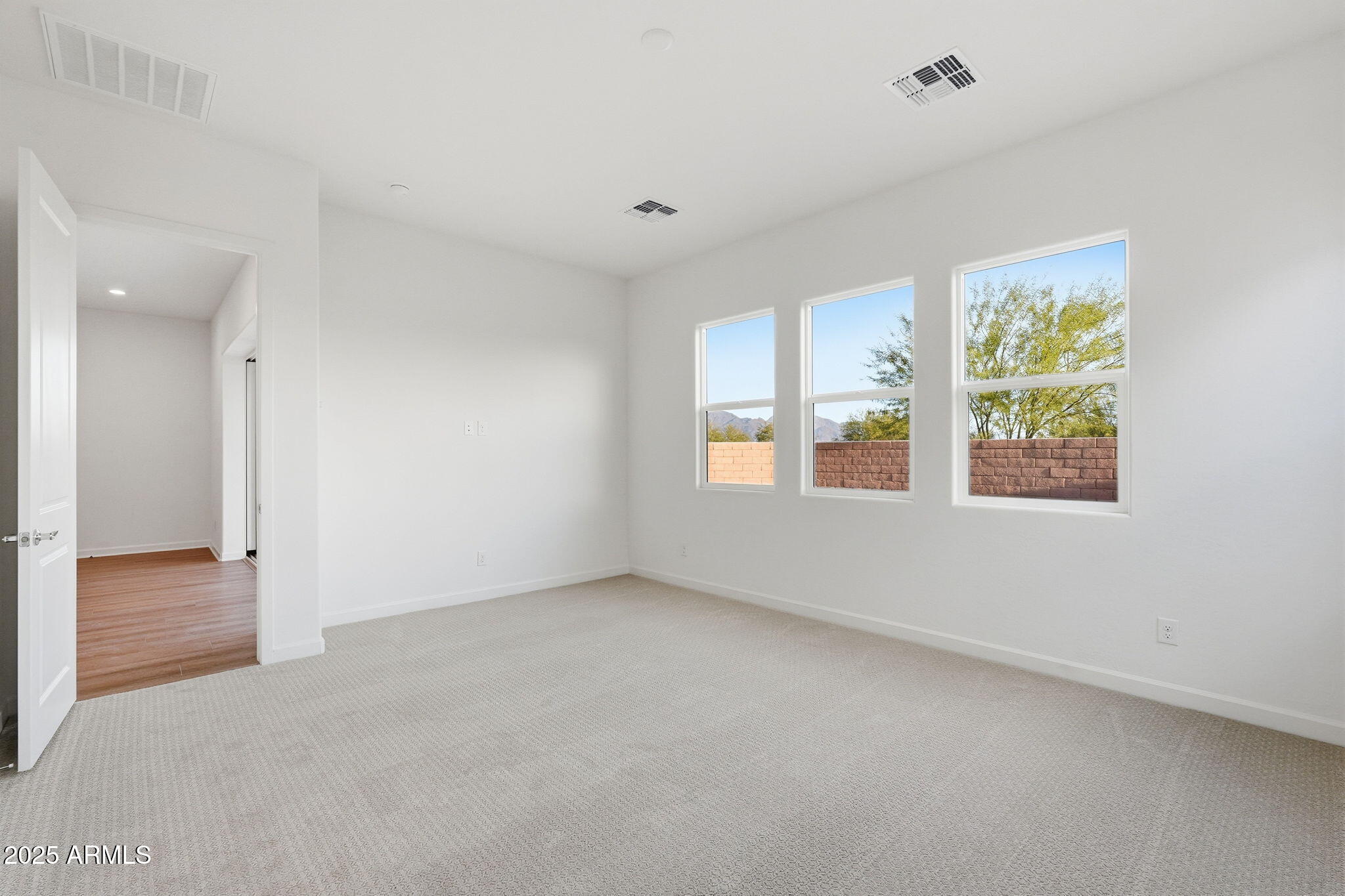 17927 West Long Lake Road Goodyear, AZ 85338 - Photo 11 of 36 an empty room with windows