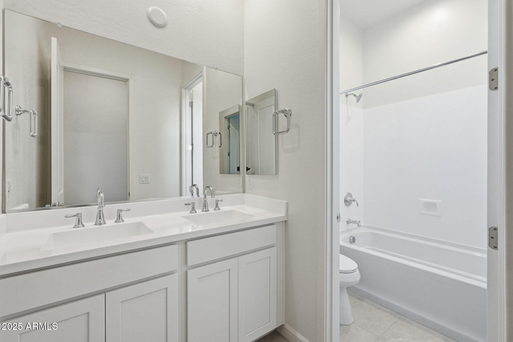 17927 West Long Lake Road Goodyear, AZ 85338 - Photo 21 of 36 a bathroom with a sink double vanity granite tub shower and a mirror