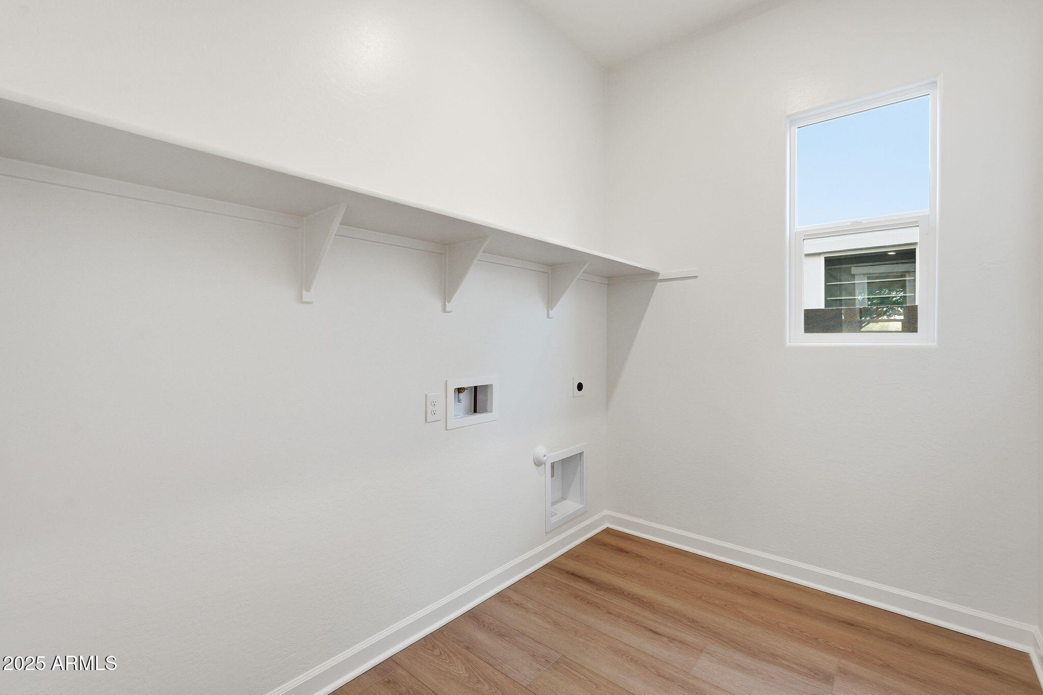 17927 West Long Lake Road Goodyear, AZ 85338 - Photo 22 of 36 a view of a room with wooden floor and white walls