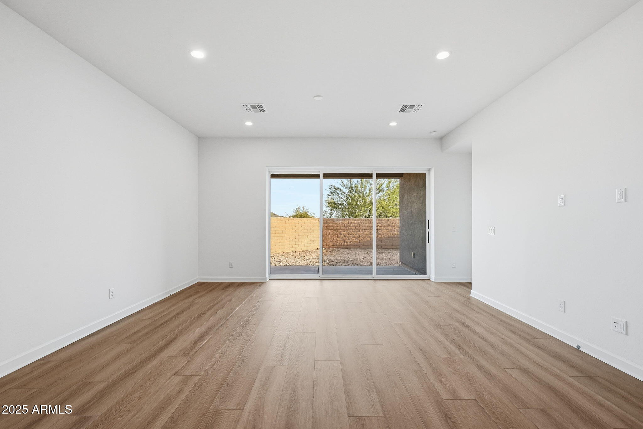 17927 West Long Lake Road Goodyear, AZ 85338 - Photo 23 of 36 wooden floor in an empty room with a window