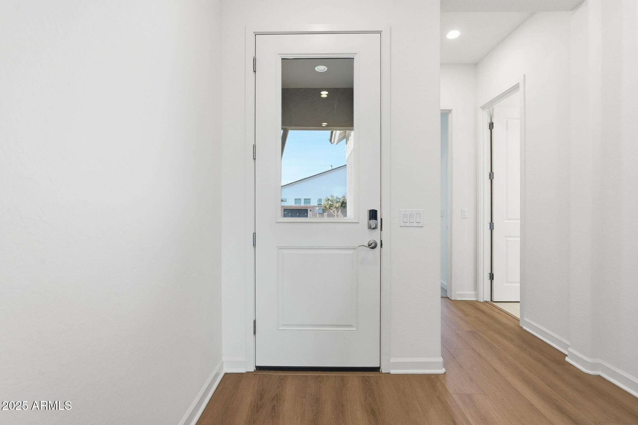 17927 West Long Lake Road Goodyear, AZ 85338 - Photo 3 of 36 a view of a hallway with wooden floor