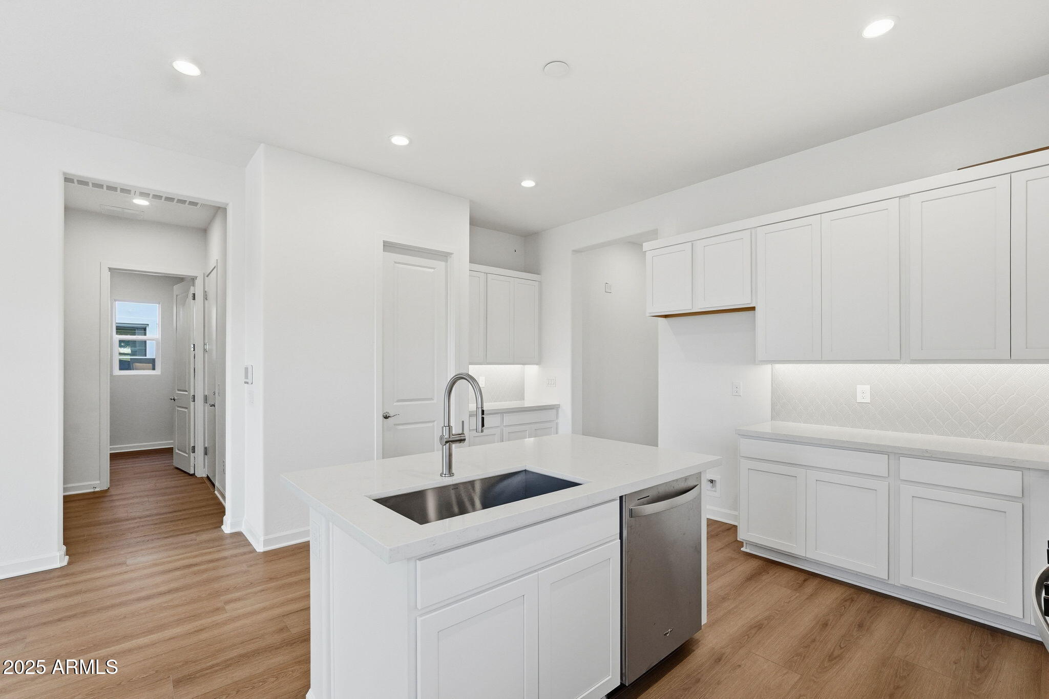 17927 West Long Lake Road Goodyear, AZ 85338 - Photo 6 of 36 a kitchen with a sink cabinets and wooden floor