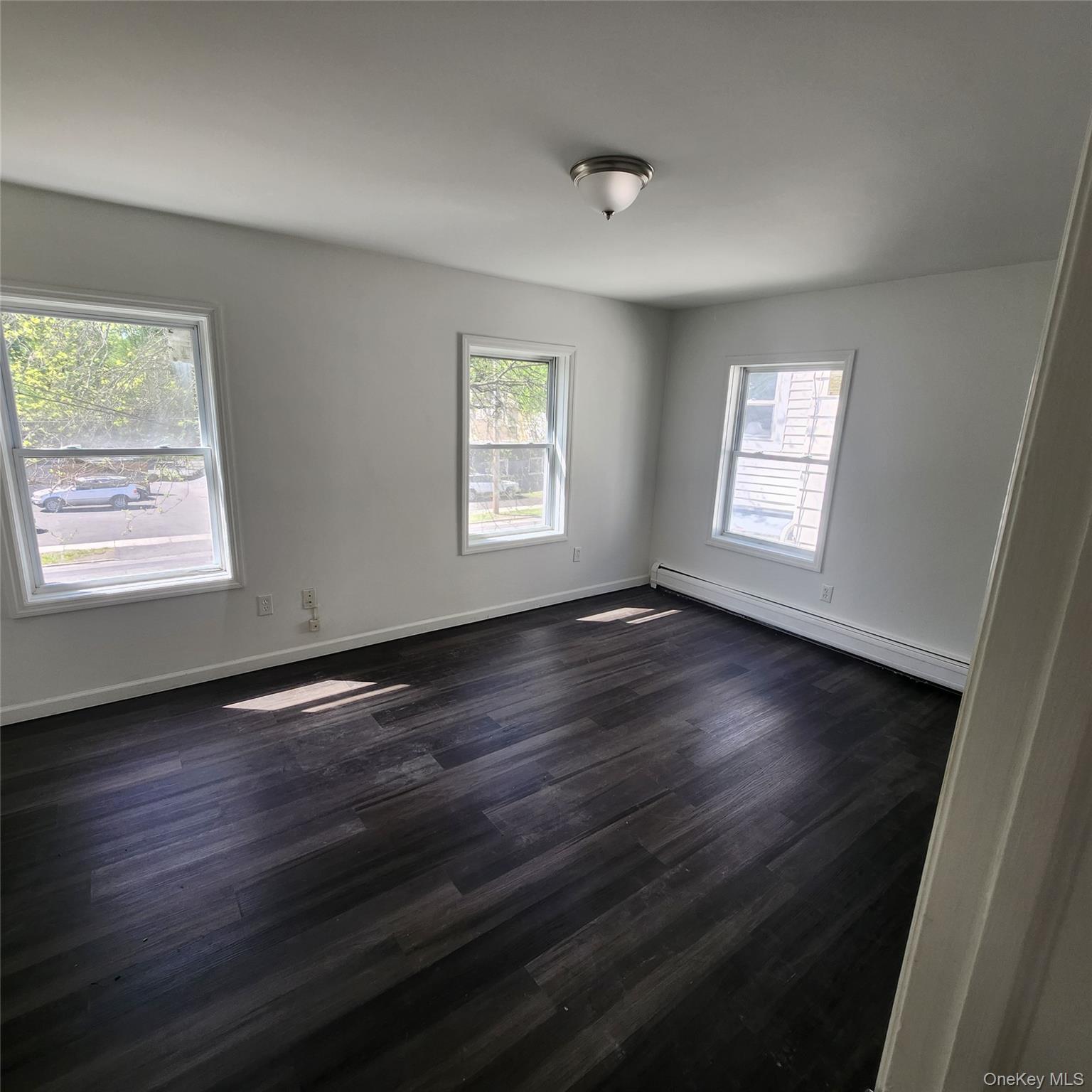 5 Morton Street Poughkeepsie, NY 12601 - Photo 11 of 23 a view of an empty room with wooden floor and a window