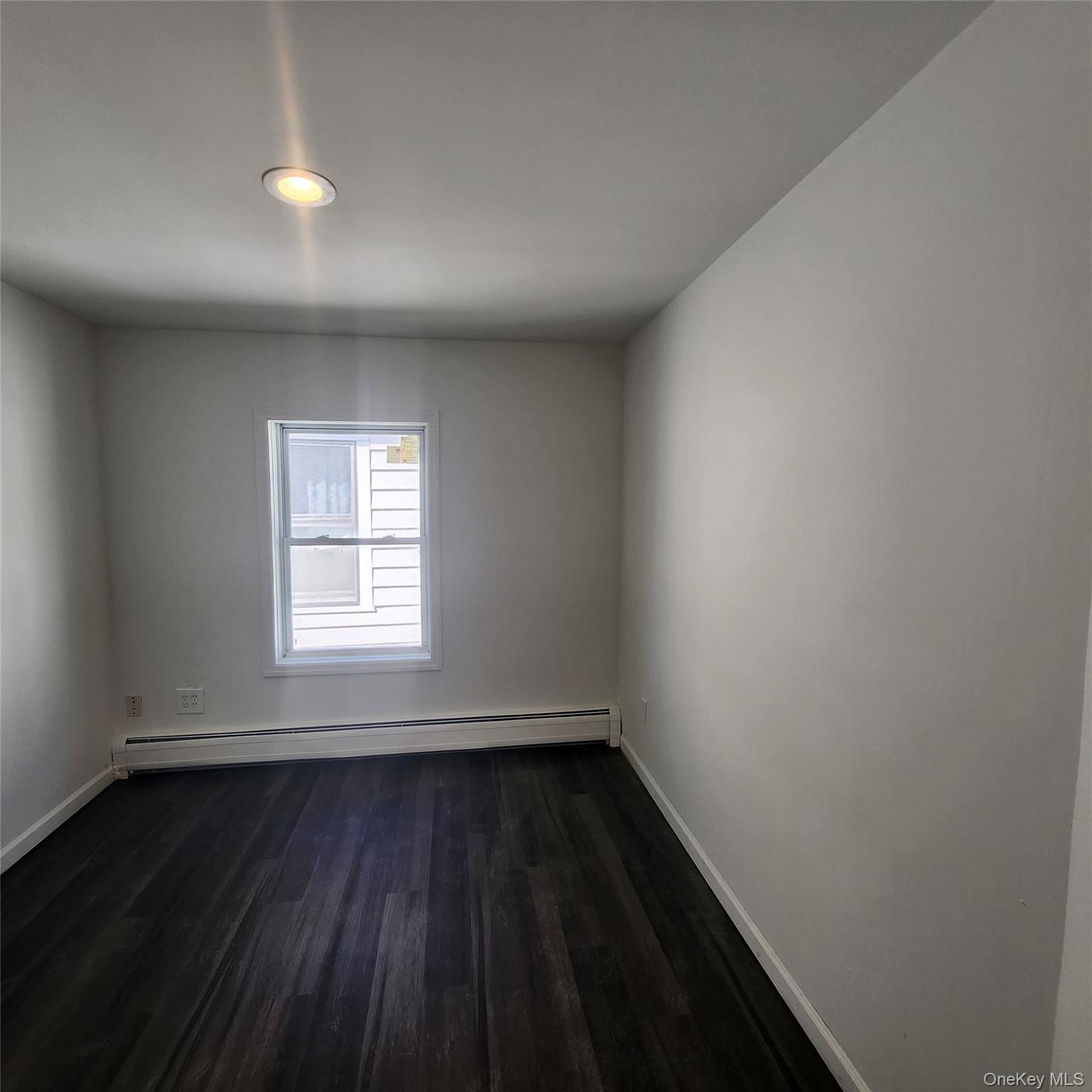 5 Morton Street Poughkeepsie, NY 12601 - Photo 12 of 23 an empty room with wooden floor and windows