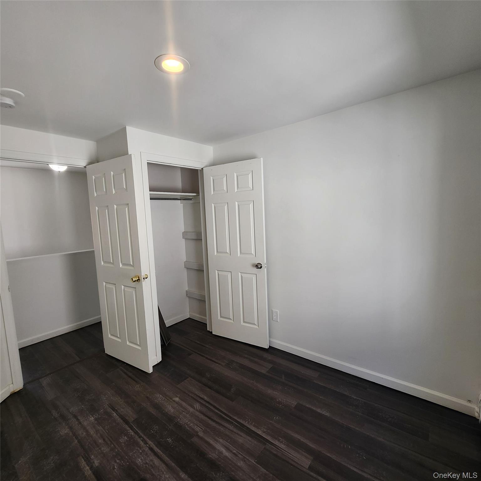 5 Morton Street Poughkeepsie, NY 12601 - Photo 13 of 23 an empty room with wooden floor and white wall