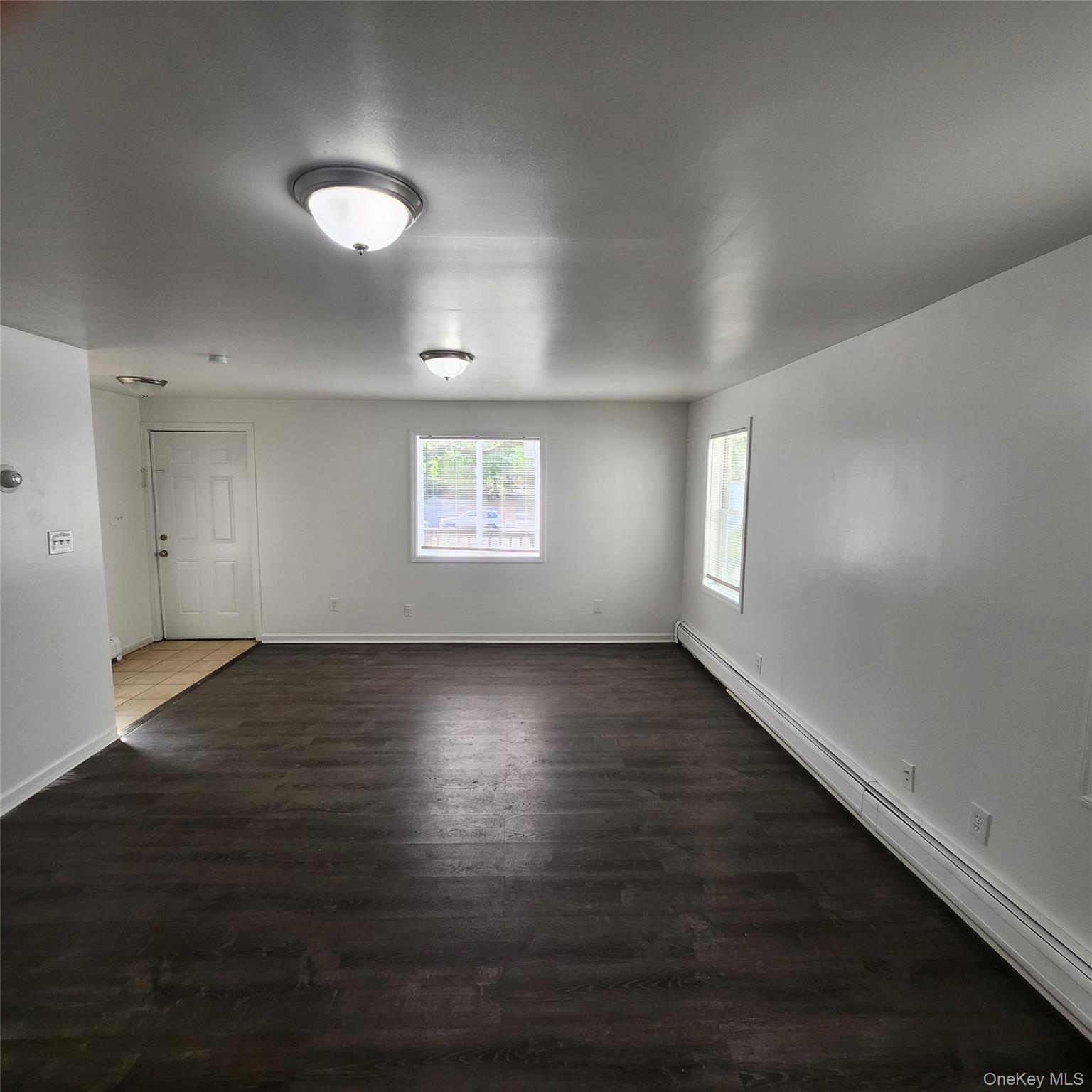 5 Morton Street Poughkeepsie, NY 12601 - Photo 20 of 23 an empty room with wooden floor and windows
