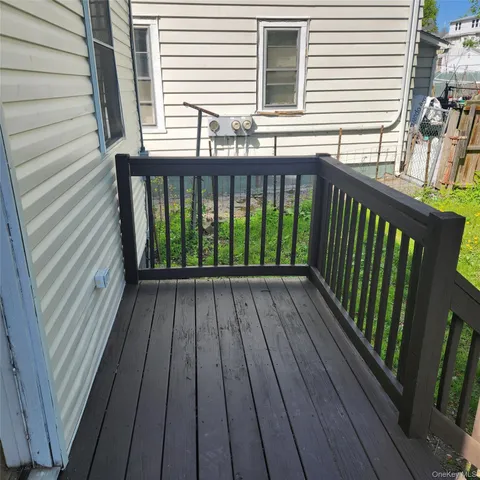 a view of a balcony with wooden floor