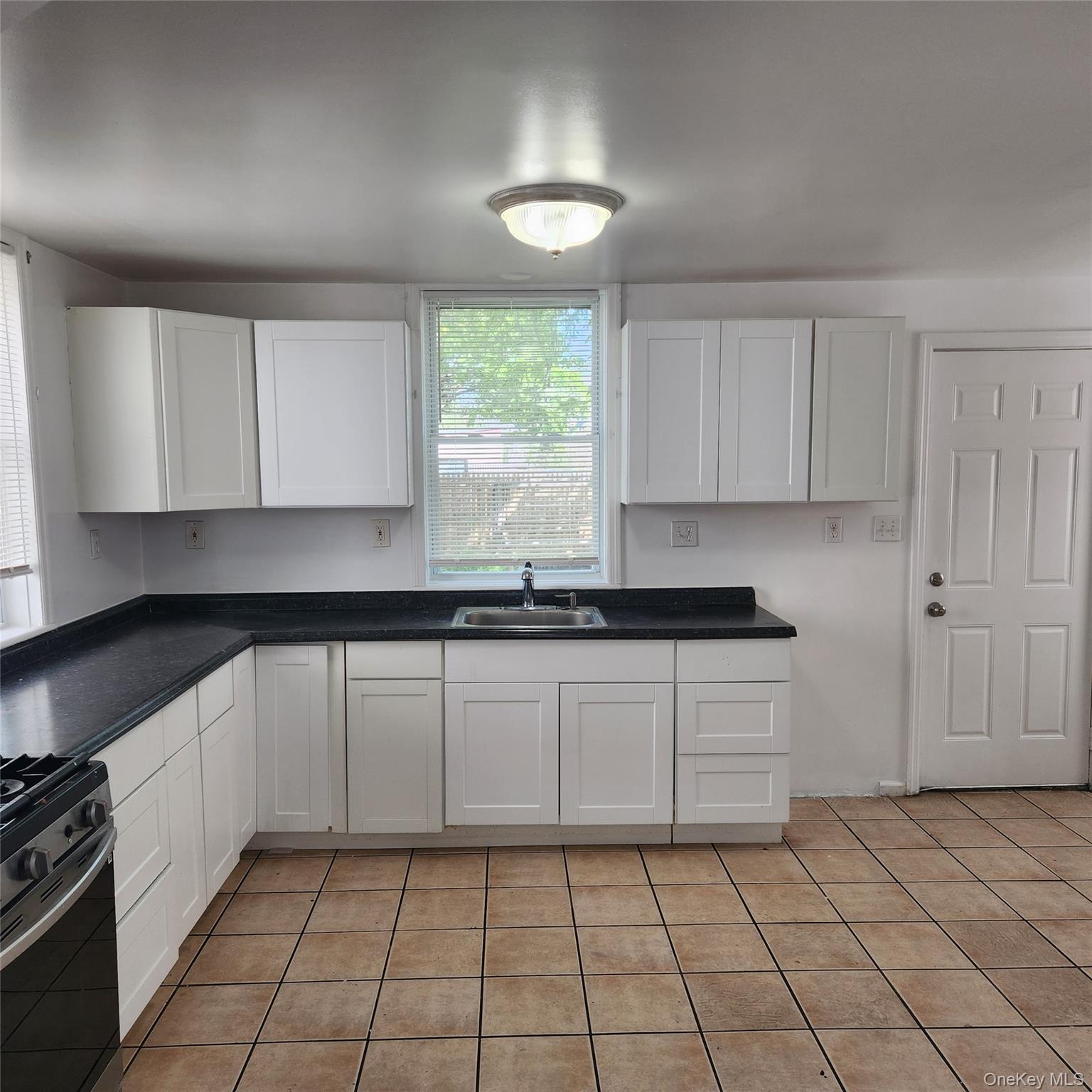5 Morton Street Poughkeepsie, NY 12601 - Photo 5 of 23 a kitchen with a sink a stove and cabinets