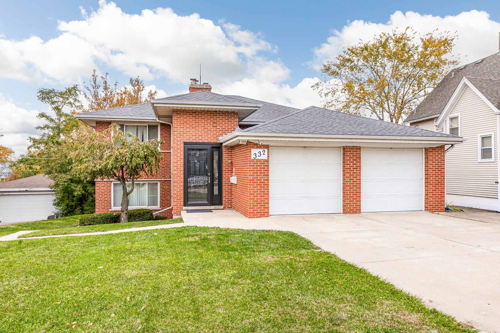 332 Maple Avenue, Unit 1 Downers Grove, IL 60515 - Photo 1 of 29 a front view of a house with a yard and garage
