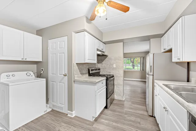 a kitchen with a stove a refrigerator and a sink