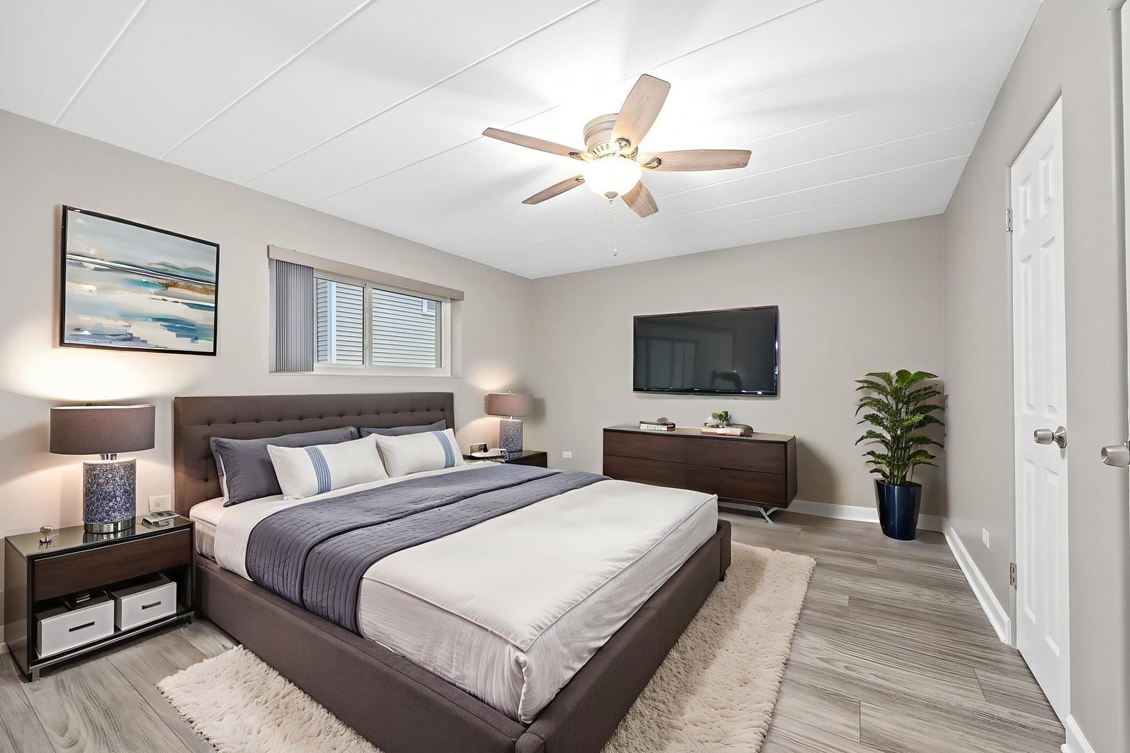 332 Maple Avenue, Unit 1 Downers Grove, IL 60515 - Photo 14 of 29 a bedroom with a bed and a flat screen tv