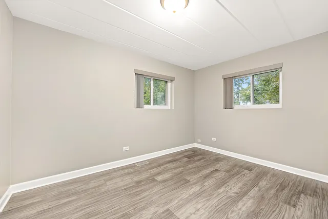 a view of room with wooden floor and window