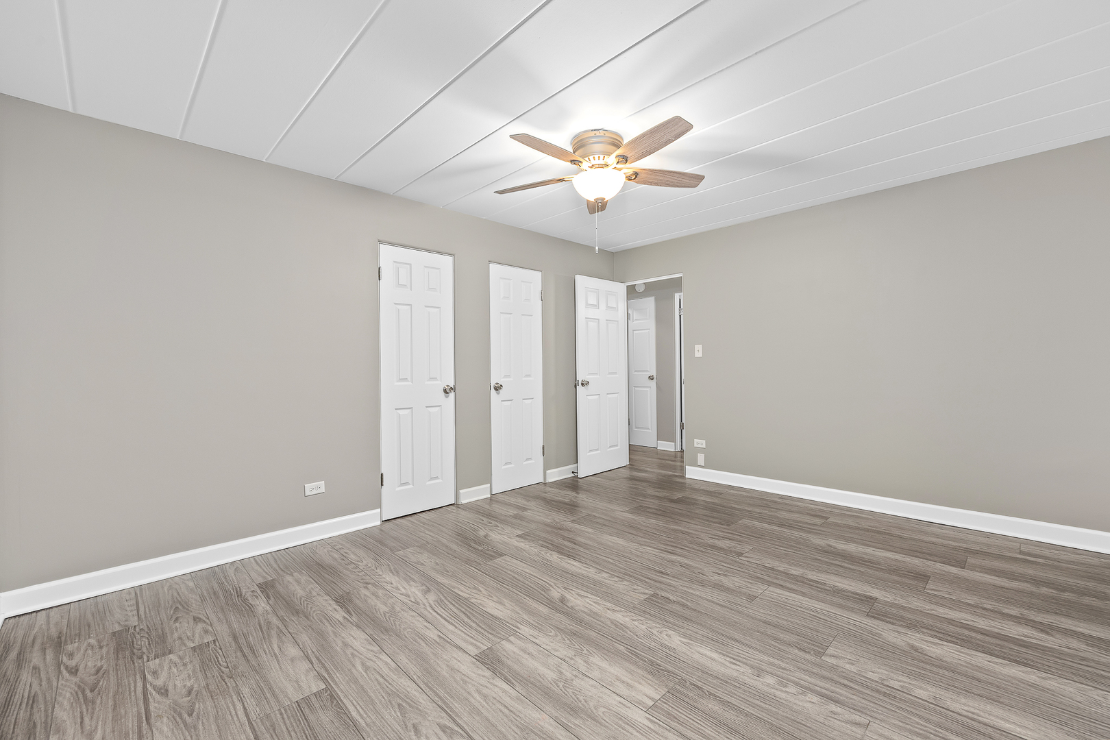 332 Maple Avenue, Unit 1 Downers Grove, IL 60515 - Photo 20 of 29 a view of an empty room with chandelier fan and wooden floor