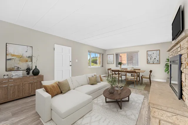 a living room with furniture flat screen tv and a fireplace
