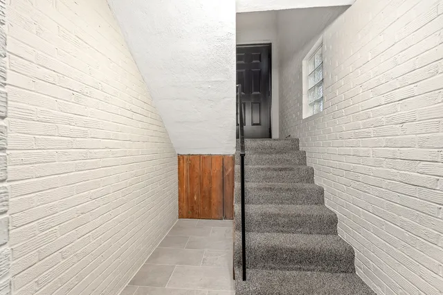 a view of staircase with white walls
