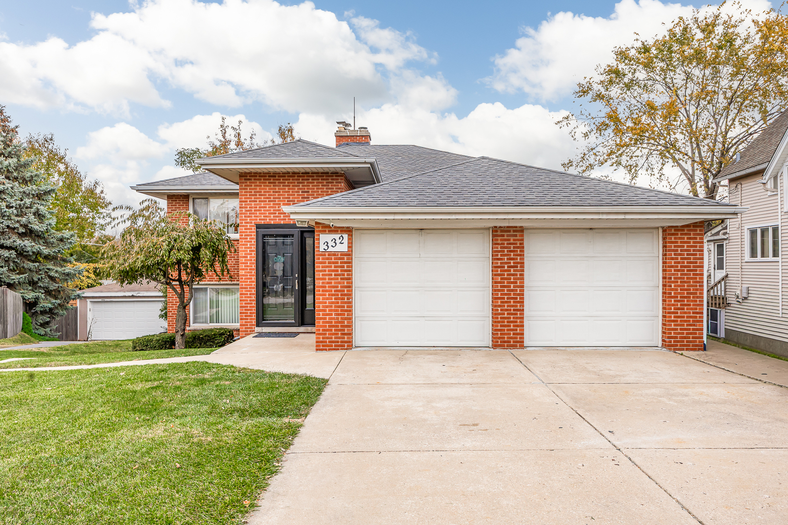 332 Maple Avenue, Unit 1 Downers Grove, IL 60515 - Photo 22 of 29 a front view of a house with a garden and trees