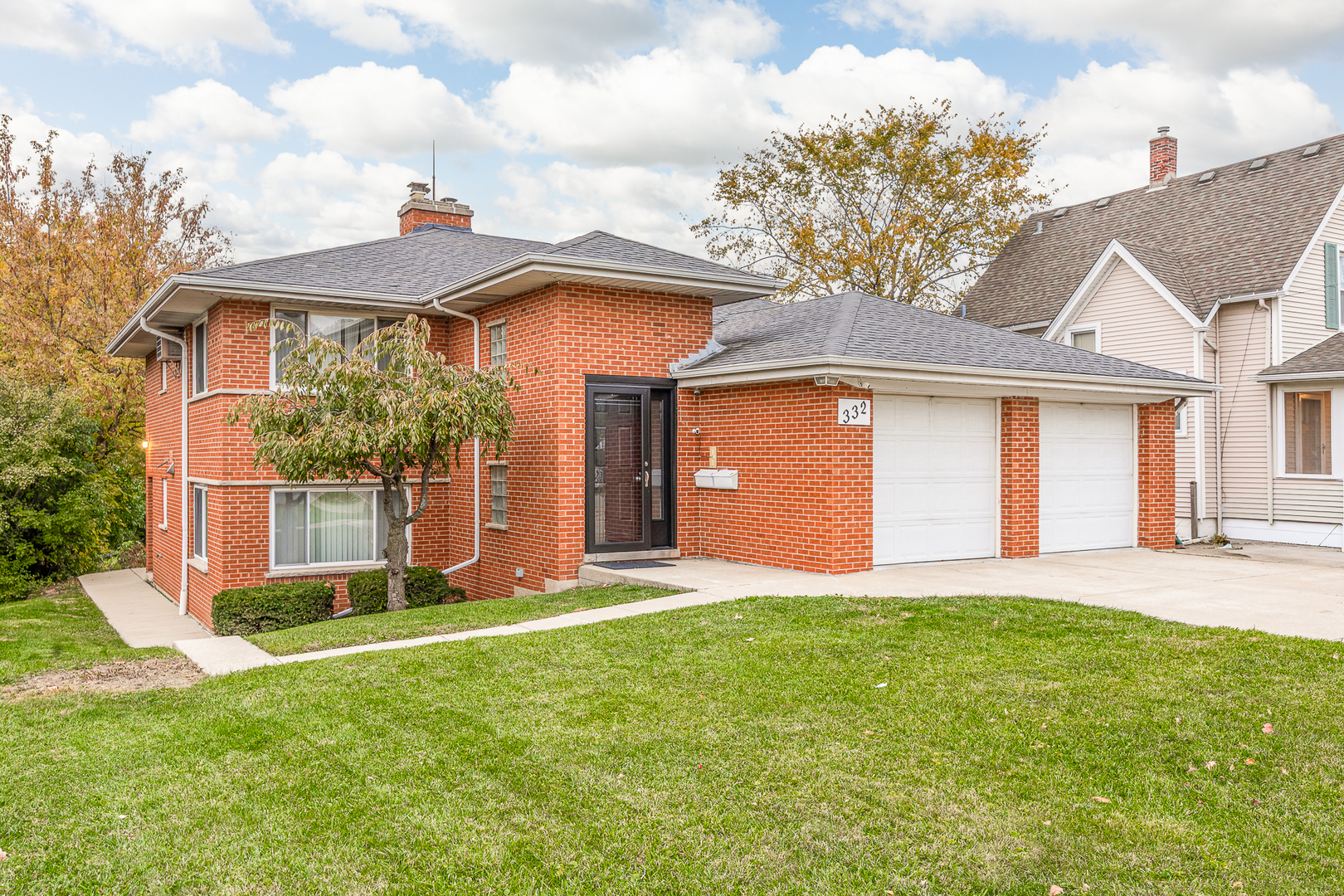 332 Maple Avenue, Unit 1 Downers Grove, IL 60515 - Photo 23 of 29 a front view of a house with a yard and garage