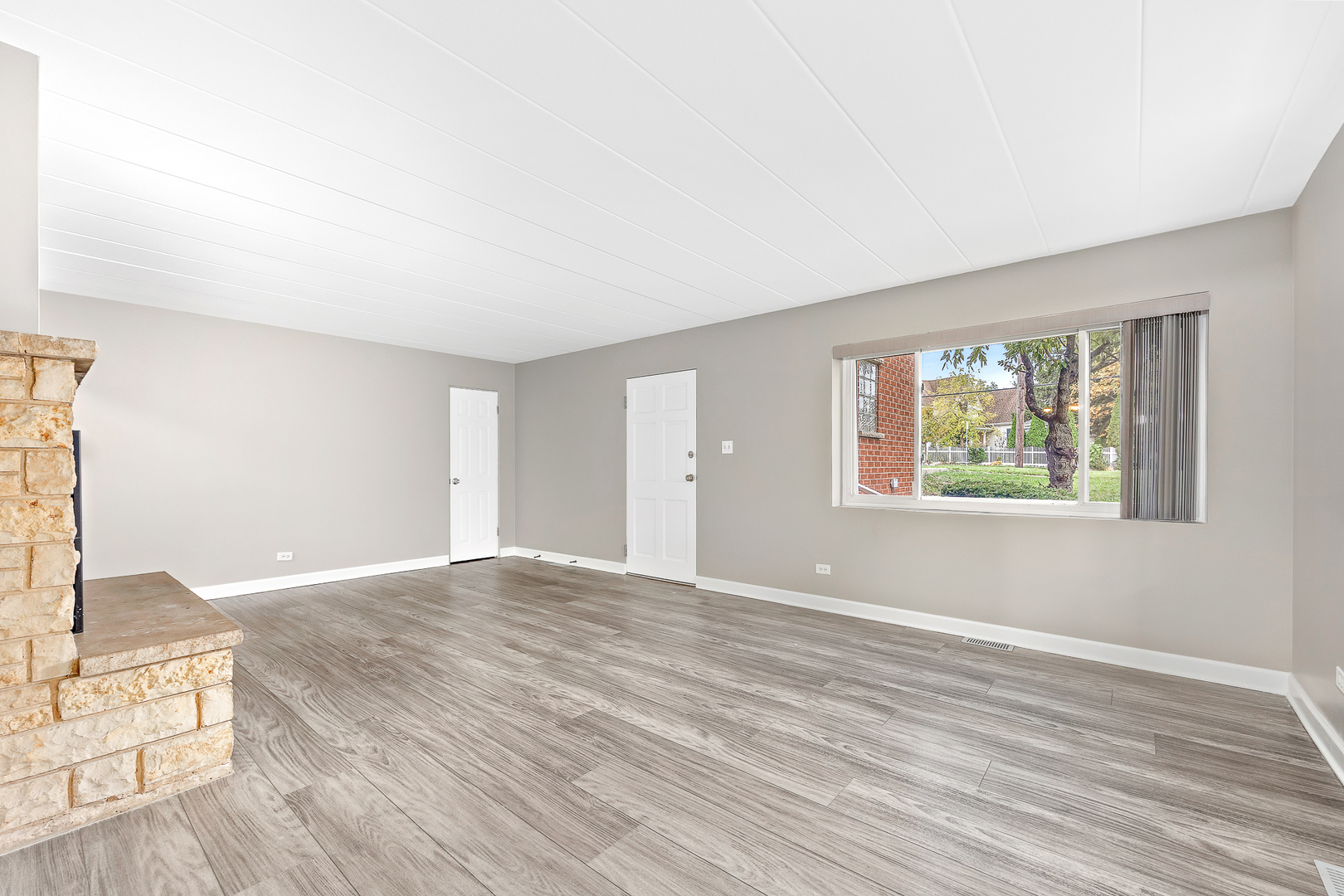 332 Maple Avenue, Unit 1 Downers Grove, IL 60515 - Photo 4 of 29 a view of an empty room with wooden floor and a window