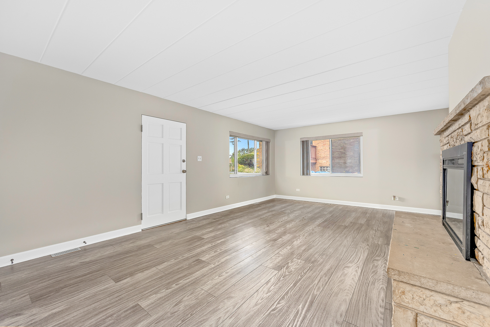 332 Maple Avenue, Unit 1 Downers Grove, IL 60515 - Photo 6 of 29 an empty room with wooden floor and windows