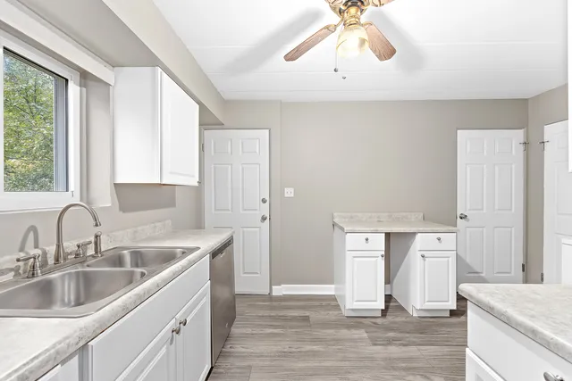 a kitchen with a sink cabinets and window