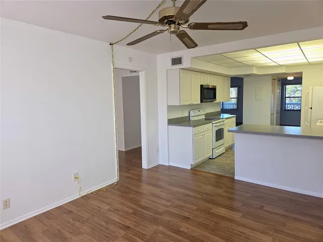 a view of a kitchen with microwave and cabinets