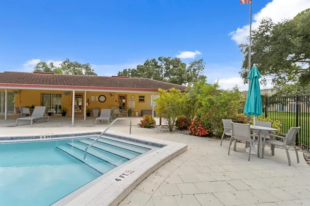 a view of a patio with swimming pool table and chairs