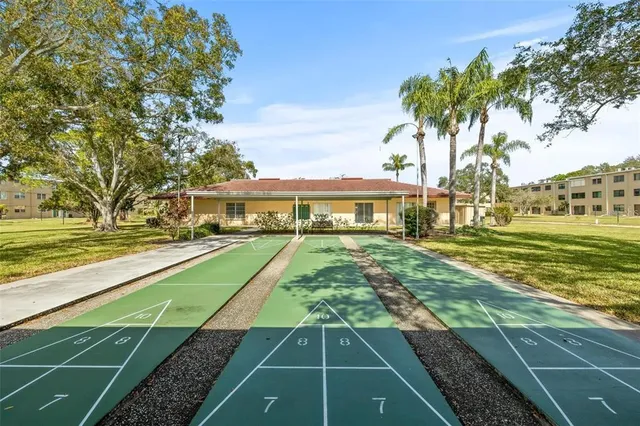 a view of yard with swimming pool and wooden fence
