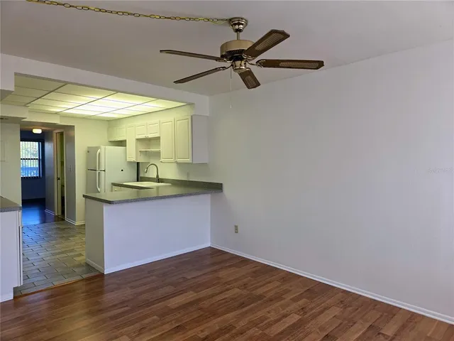 a view of a kitchen with a dishwasher and wooden floor