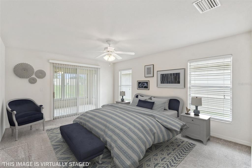 142 Morning Glory Circle Winter Haven, FL 33884 - Photo 16 of 36 a spacious bedroom with a bed a couch and a window