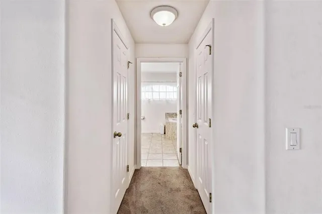a view of a hallway with a wooden door