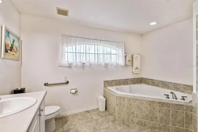 a white bath tub sitting next to a white toilet