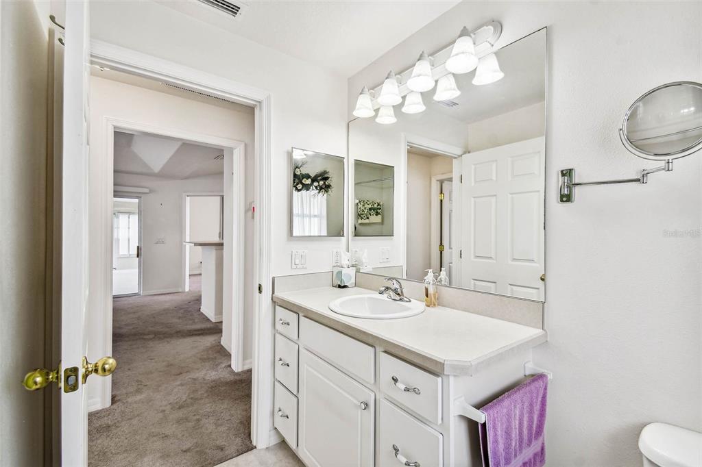 142 Morning Glory Circle Winter Haven, FL 33884 - Photo 24 of 36 a bathroom with a sink vanity and a mirror