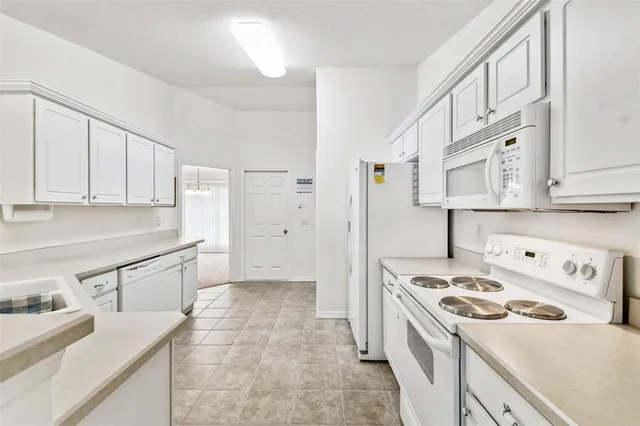 a kitchen with a sink stove and refrigerator
