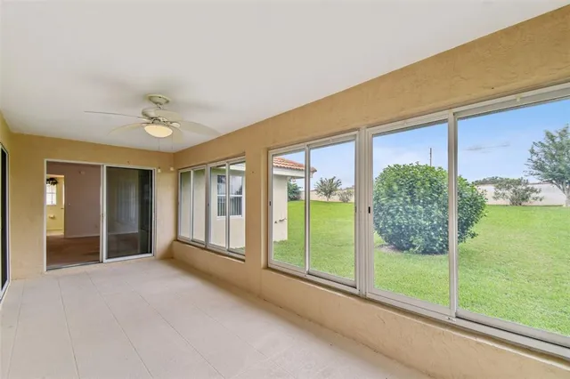 a view of a big room with windows and entryway