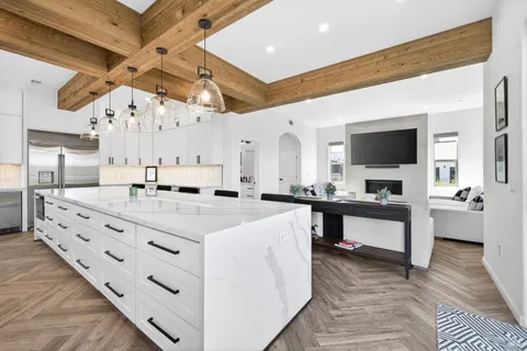 a kitchen with a dining table chairs and window