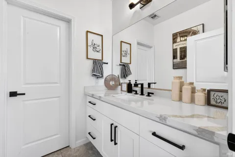 a bathroom with a toilet sink and mirror