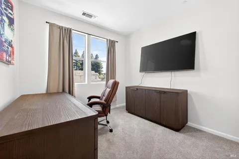 a roof deck with couches and wooden floor
