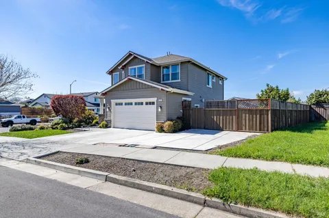 a large white kitchen with lots of counter space a sink and stainless steel appliances