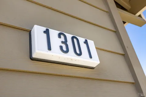a kitchen with a refrigerator sink and cabinets